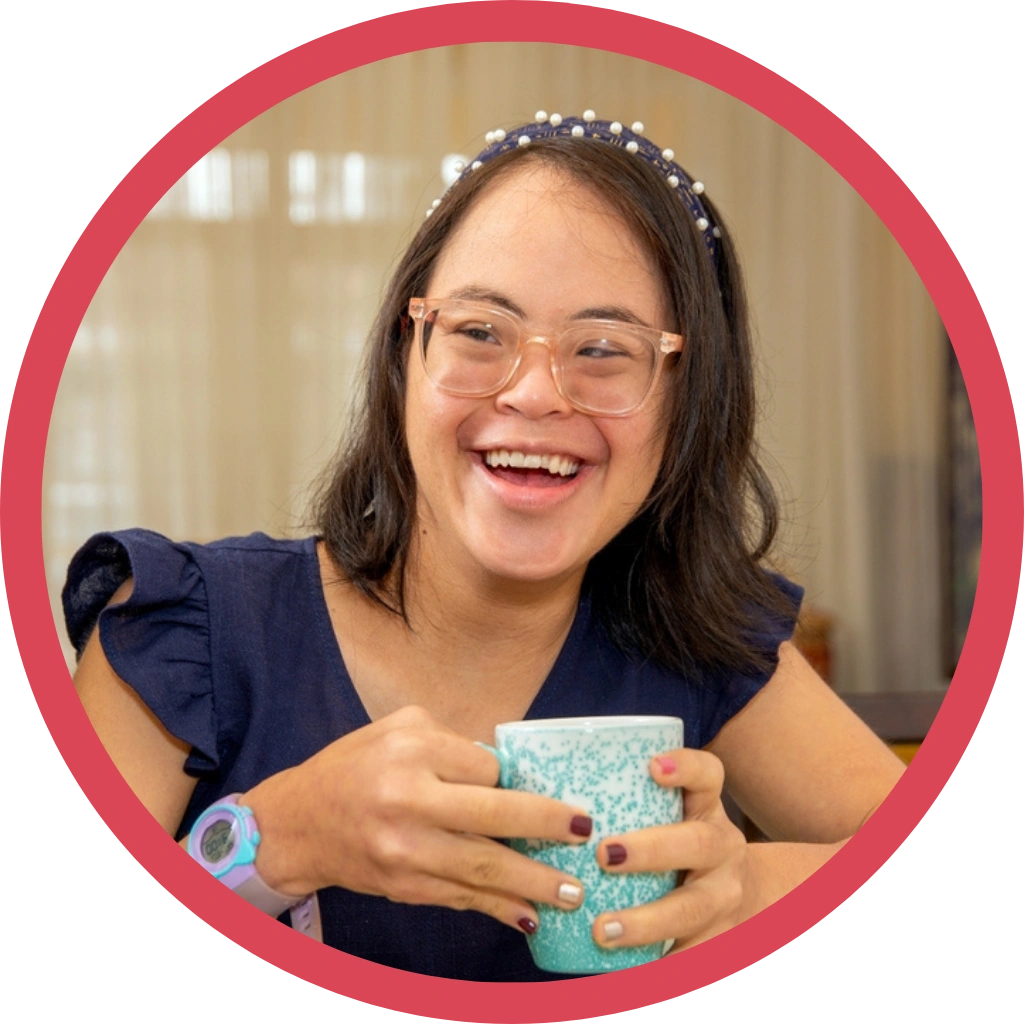 young, playful girl with down syndrome disability having coffee